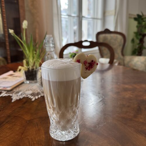 Frisch zubereiteter Latte Macchiato auf einem Holztisch im Café